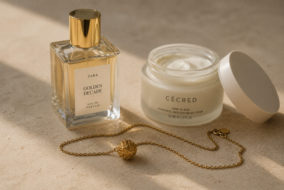 Perfume e creme ao lado de uma joia
